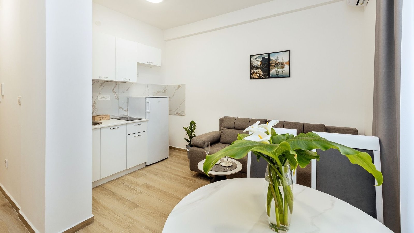 Modern living area with sofa and dining space in a one-bedroom apartment in Herceg Novi.